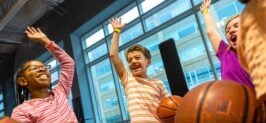 Kids cheering and playing Air Court Basketball at Sky Zone